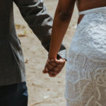 closeup of the couple holding hands.
