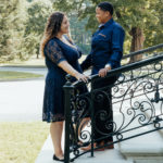 image of brides to be holding hands on the steps of vanderbilt mansion.