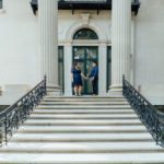 image of brides to be holding hands on the steps of vanderbilt mansion.