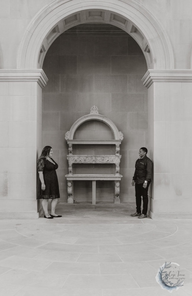 black and white photo of brides to be standing under an archway.