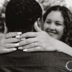 black and white image of bride smiling and close up of engagement ring.