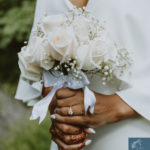 a closeup shot of the bride's bouquet and her engagement ring. Intimate Wedding in Central Park
