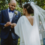 a photo of the groom placing the wedding ring on the bride's hand. Small Wedding in NYC.