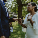 a close up shot of the bride placing the wedding ring on the groom's hand. Small central park wedding.