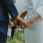 a closeup shot of the bride and groom holding hands. Small central park wedding.