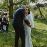 a photo of the bride and groom sharing their first kiss as husband and wife. Small central park wedding.