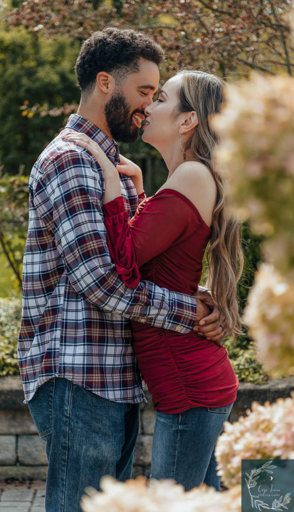 newly engaged couple sharing the moment before the kiss.