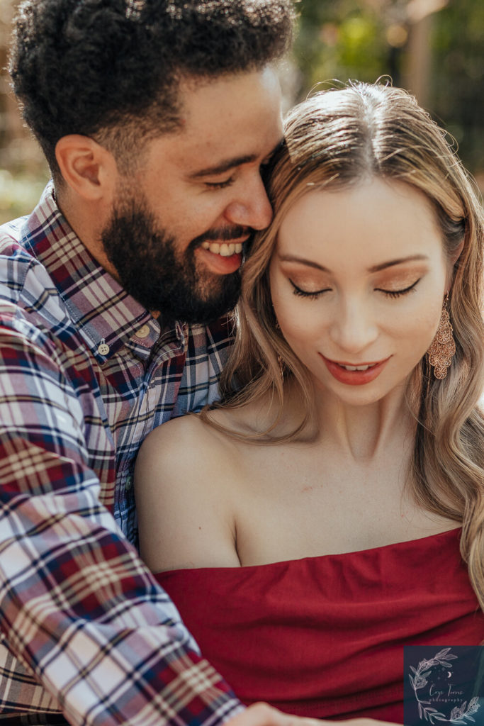 newly engaged couple embracing.