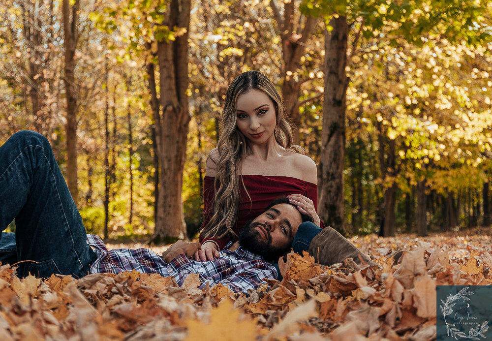 Newly engaged poses in the fall foliage at Orange County Arboretum.