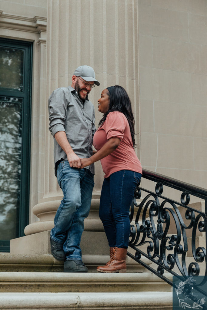 Newly engaged couple stands on steps of Vanderbilt Mansion.