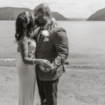 black and white photo of the couple kissing by the water. Elopement at Plum Point Park