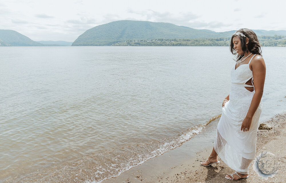 closeup of the bride in her wedding dress by the water. How to Dress for your Elopement