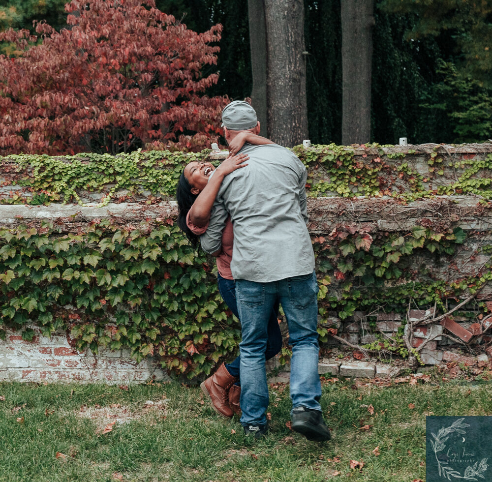 newly engaged couple embracing and laughing together. Engagement Session at Vanderbilt Mansion