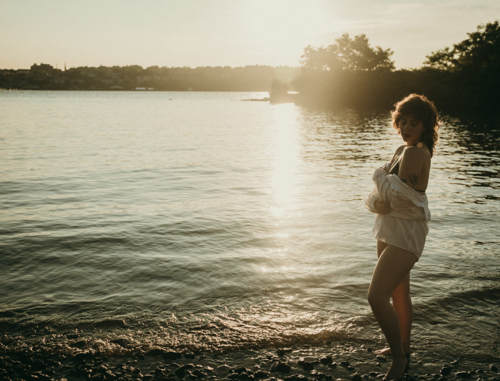 young woman stands at the riverfront. Long Dock Park, Beacon NY