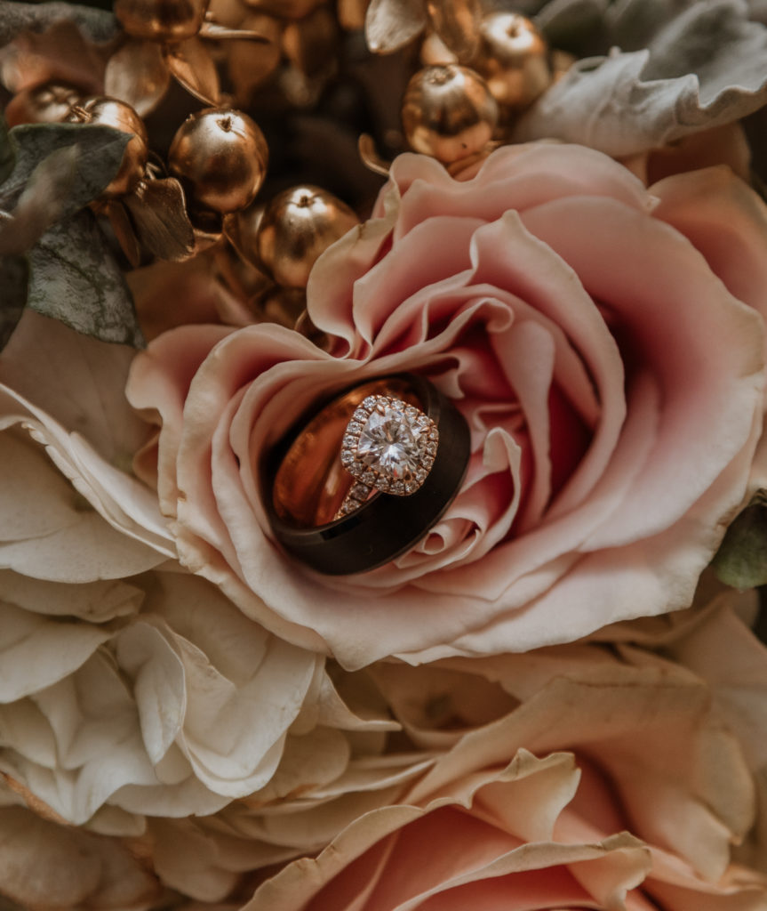 close up shot of wedding rings in bouquet