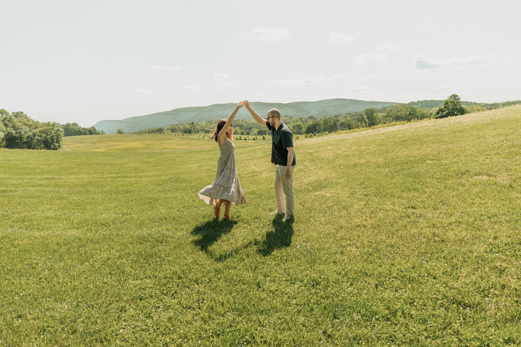 couple dancing in open field. newly engaged. surprise proposal. new york hudson valley