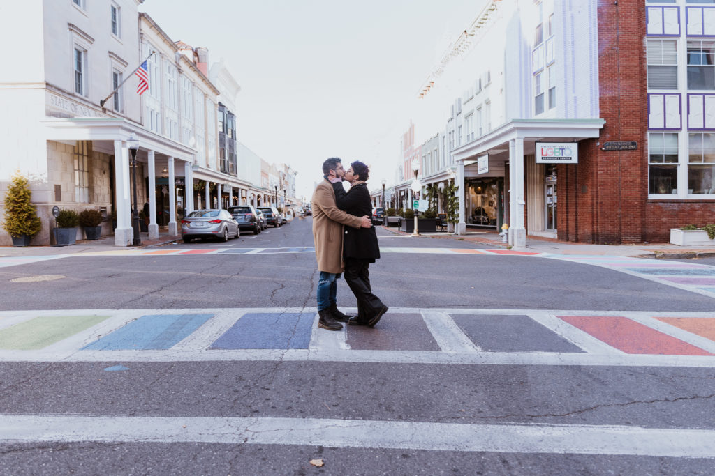 couple kissing in street downtown kingston ny engagement session winter