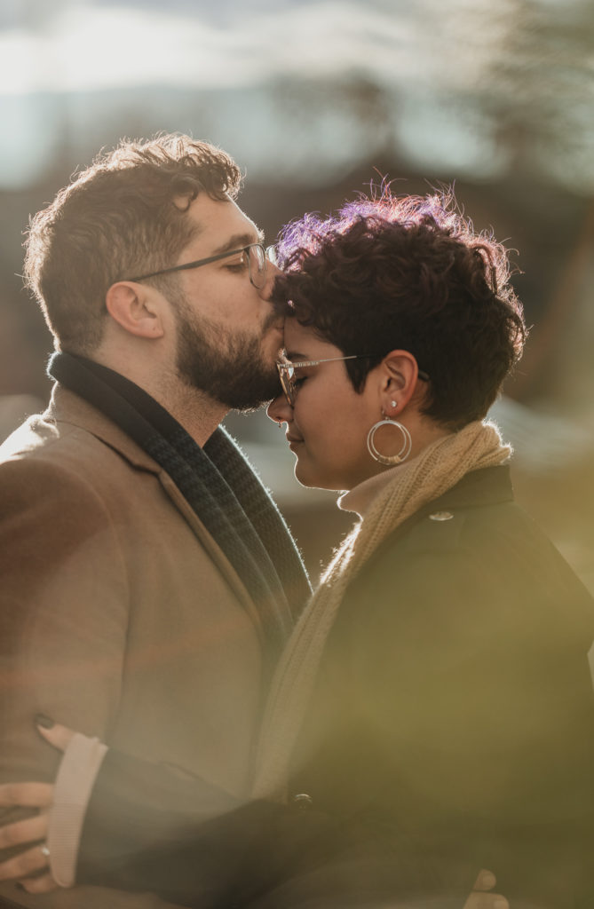 man kisses woman on forehead newly engaged hudson valley kingston new york crys torres photography