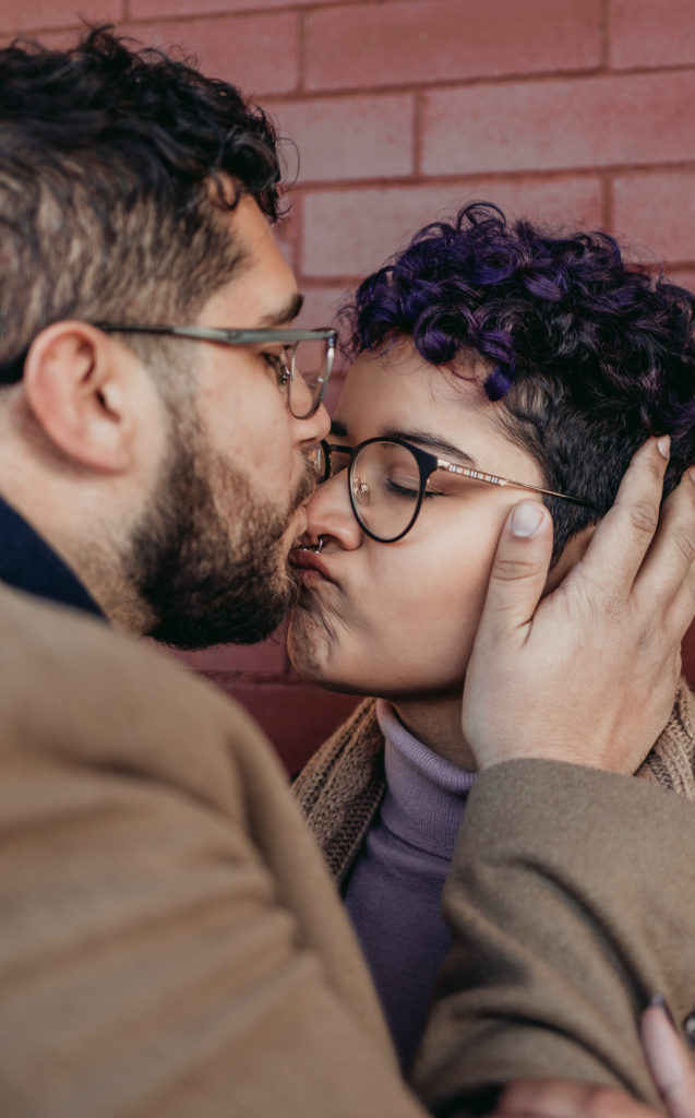 close up of couple snuggling and kissing winter engagement session