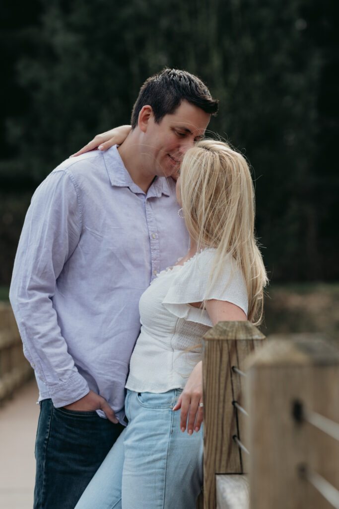 Engagement Session at Kenneth L. Wilson Campground. Woodstock, NY. couple walking on bridge. beautiful landscape, grooms picks up bride. couple locked in embrace.